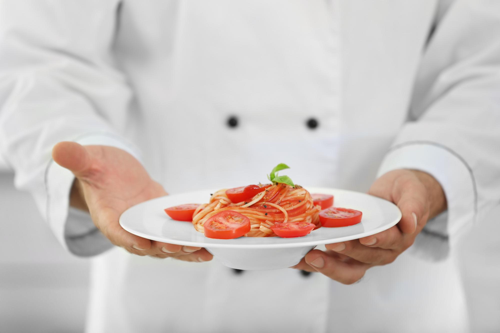 Chef preparing plated dish in studio